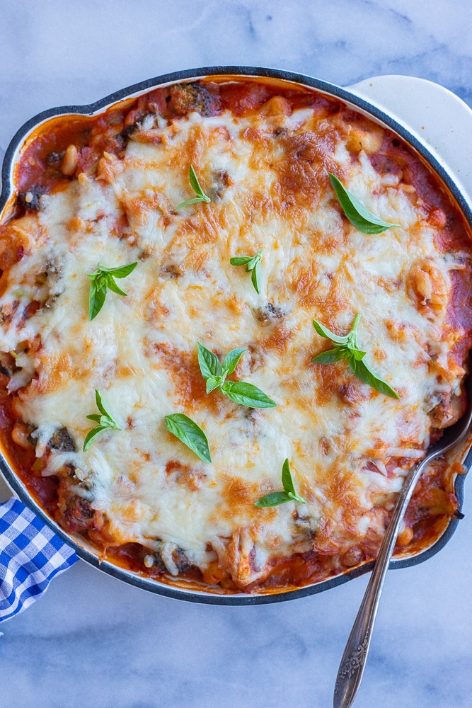 gnocchi bake in a pan with melted cheese and fresh basil