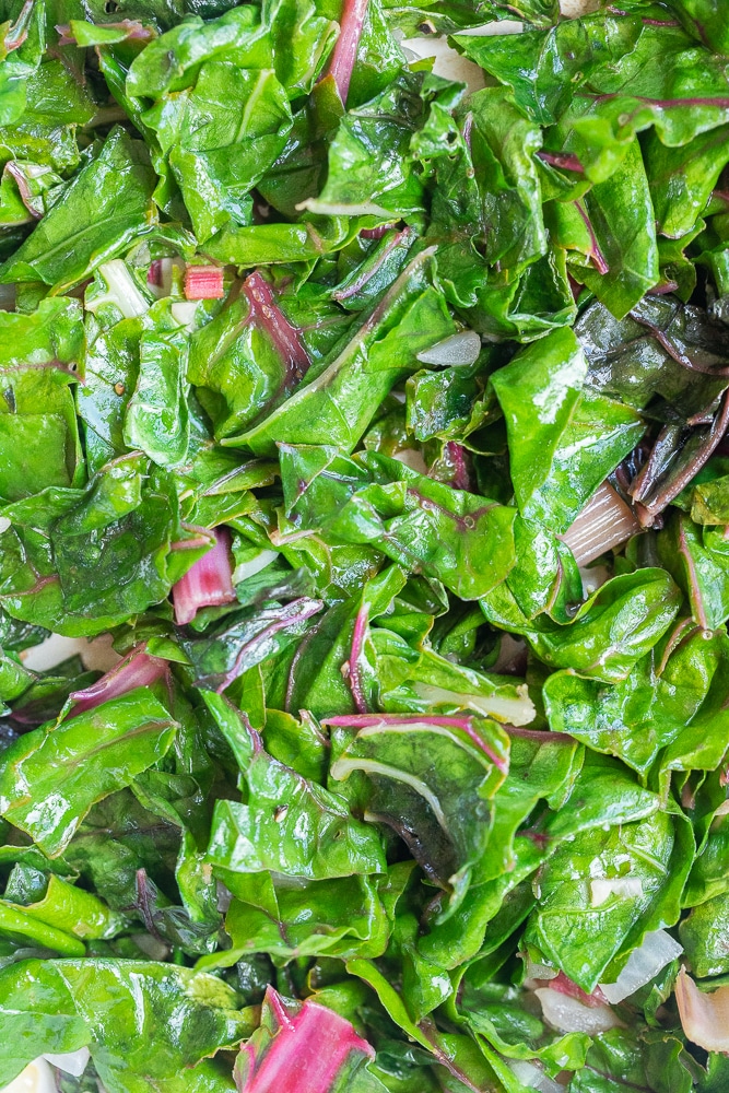 close up of swiss chard being cooked in a pan