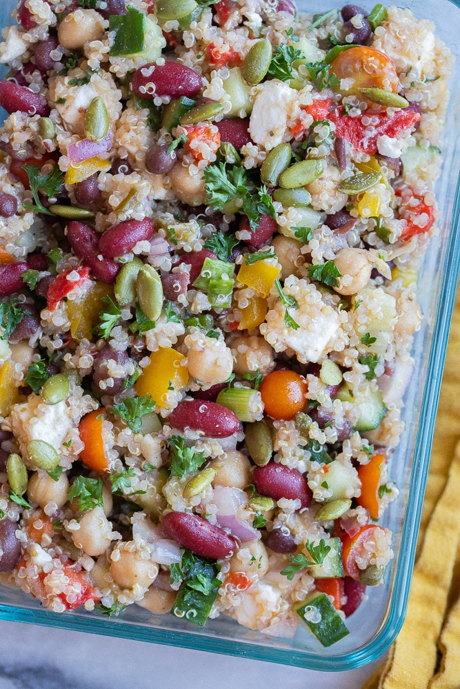 close up of a food storage container filled with protein packed 3 bean quinoa salad