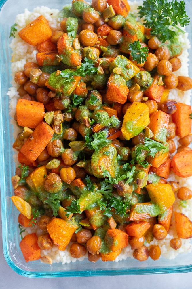 close up of a meal prep container filled with Roasted Carrot and Couscous salad with lemon parsley 