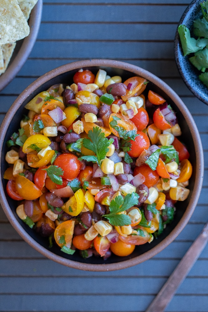 bean and corn salsa with cherry tomatoes in a serving bowl