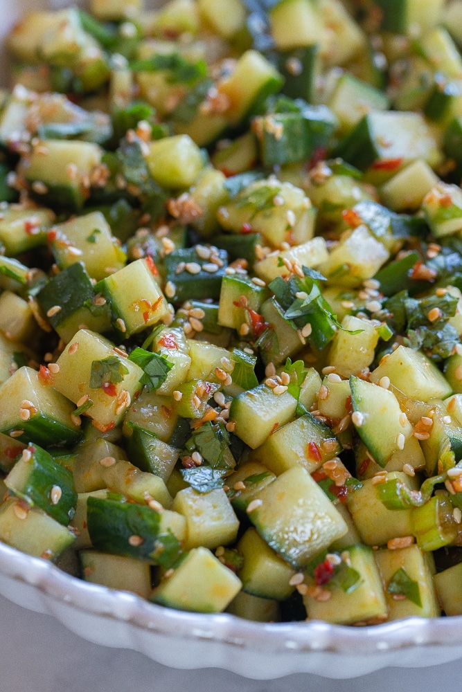 close up of chili garlic cucumber salad in a serving bowl