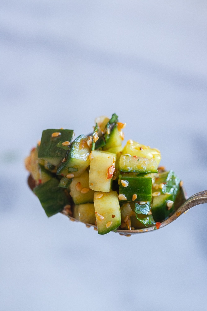 spicy cucumber salad on a spoon