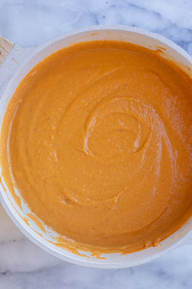 big pot of creamy pumpkin soup with pinto beans