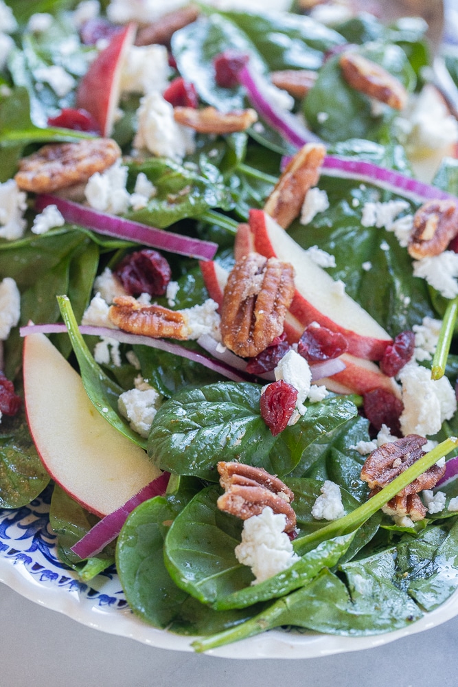 simple spinach salad on a serving platter