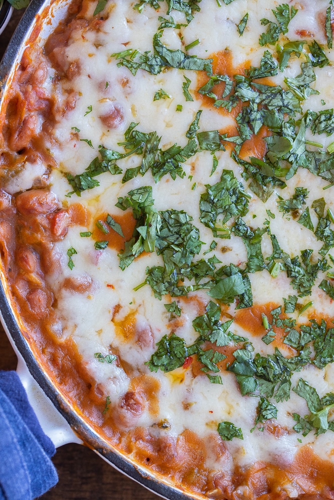 close up of a pan of pepper jack pinto beans with green chile