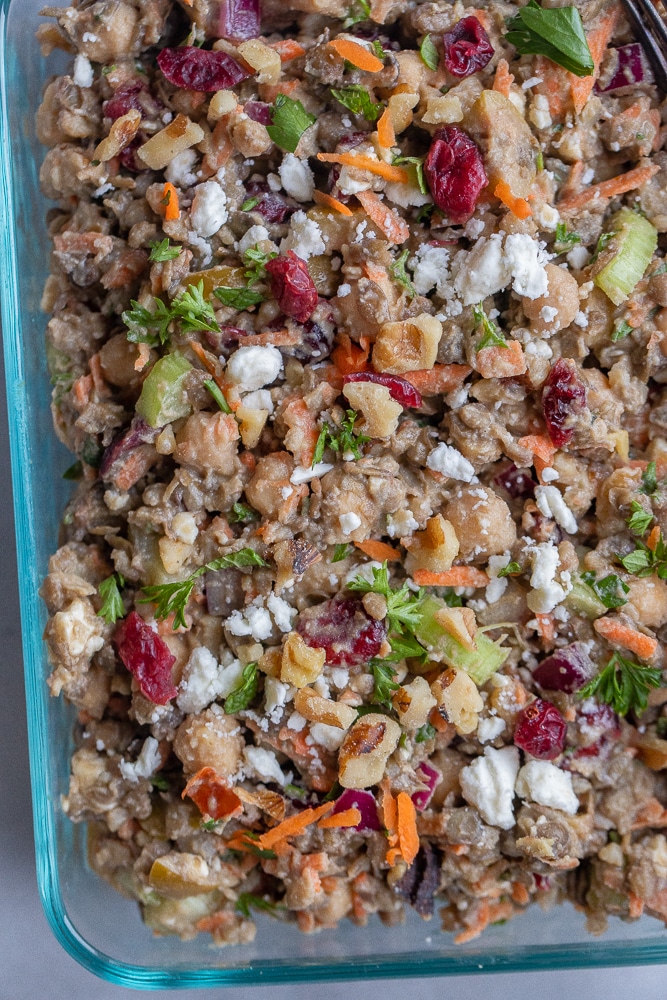 close up of my loaded lentil salad in a meal prep container topped with feta cheese