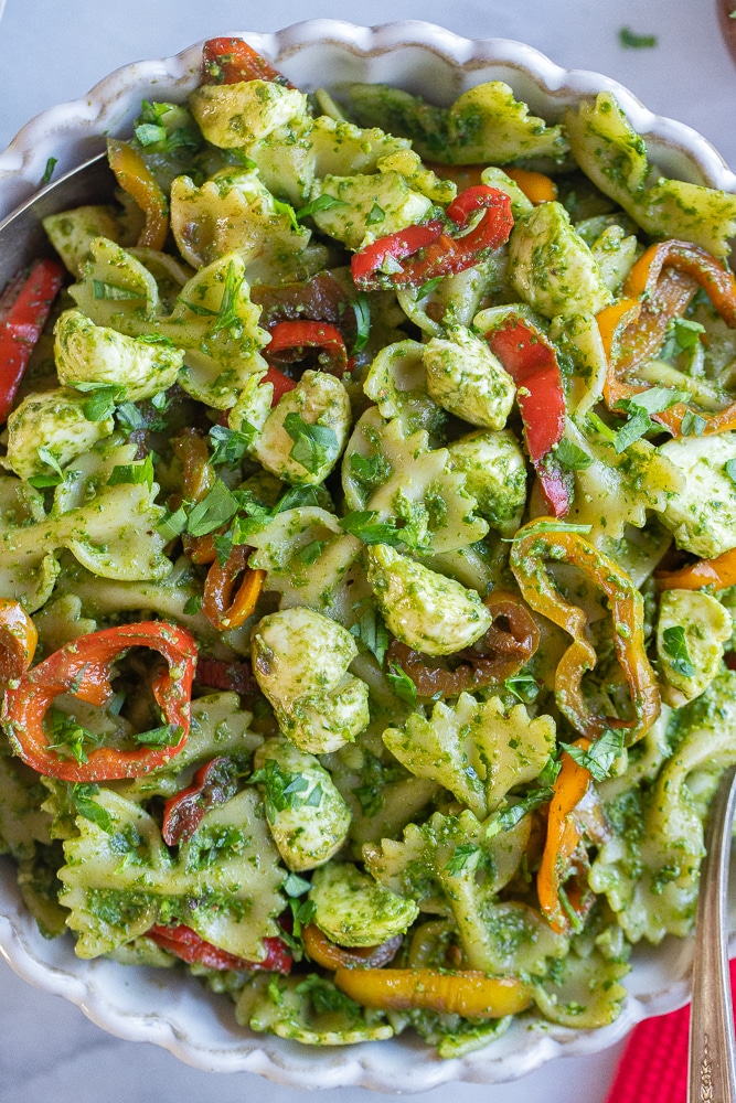 close up of this holiday pesto pasta salad in a large serving bowl