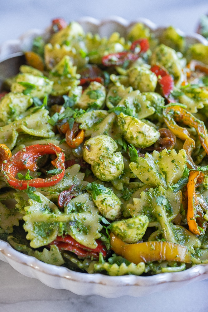 close up of pesto pasta salad with balsamic sweet peppers