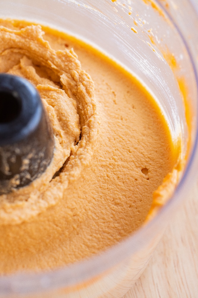 creamy buffalo flavored hummus in a food processor