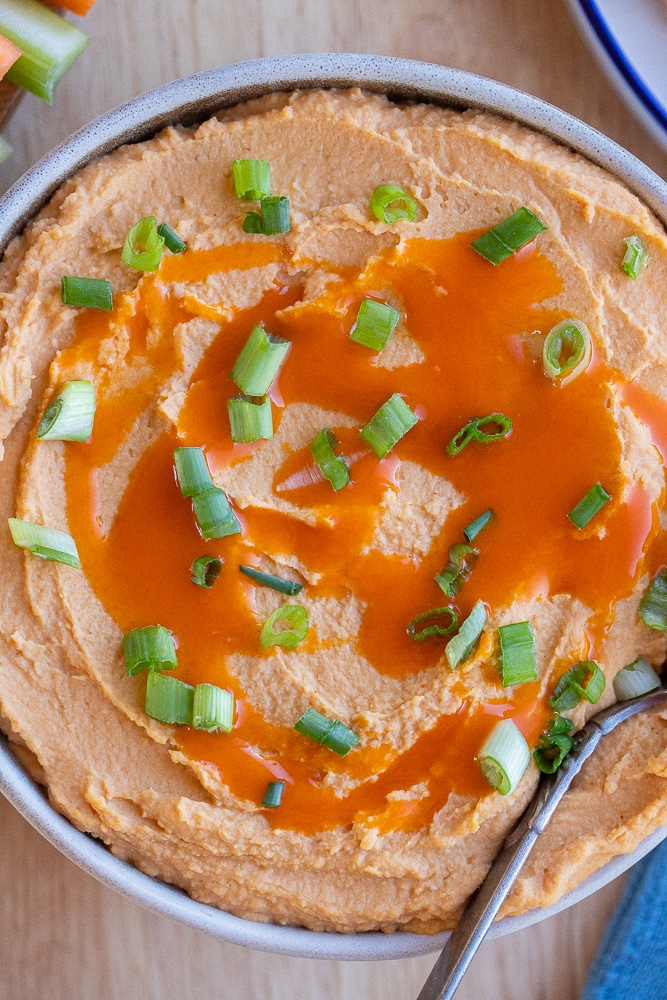 Close up of a bowl of buffalo hummus dip