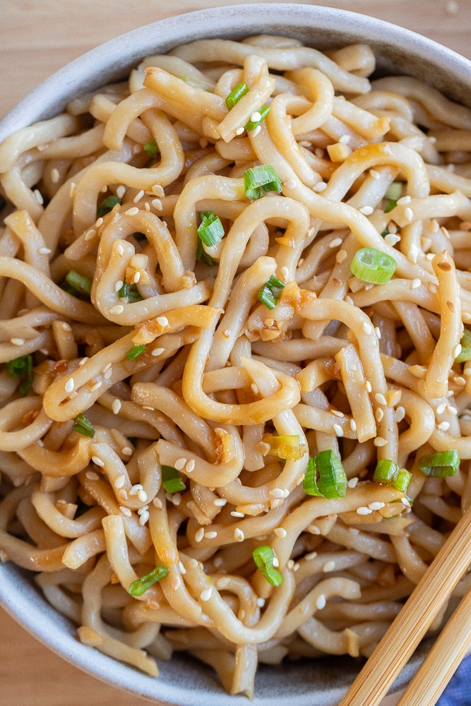 close up of garlic noodles in a bowl