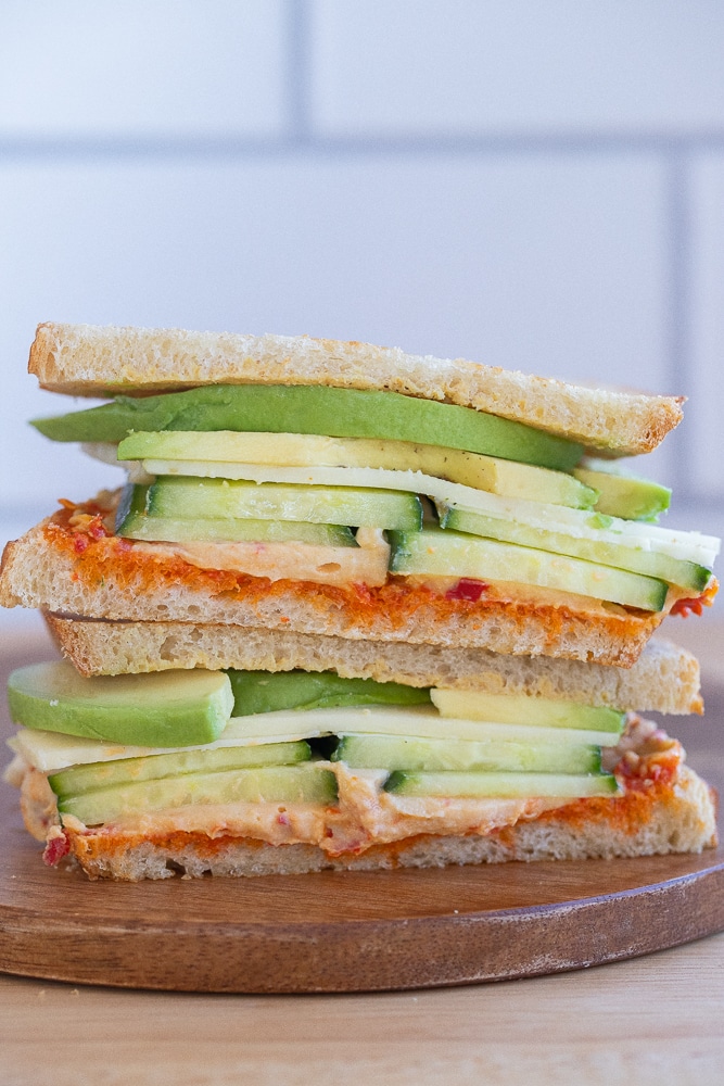 a hummus and avocado sandwich cut in half and stacked on top of eachother