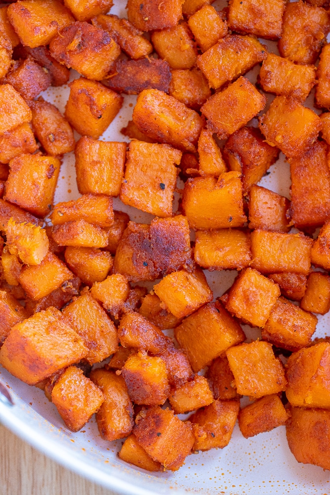 close up of the seasoned sweet potatoes in the pan