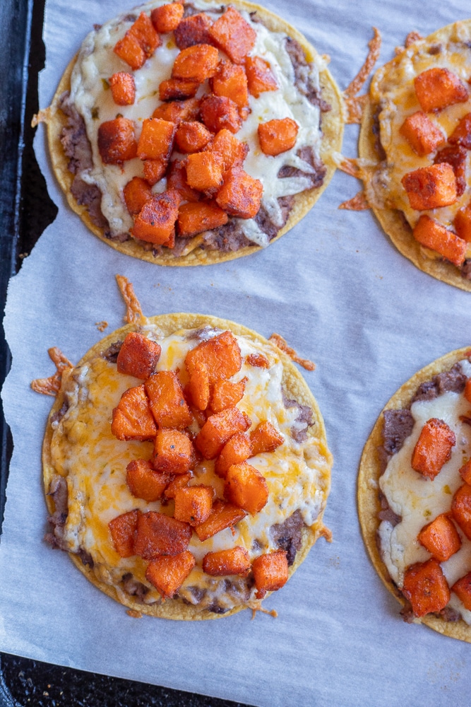 cheesy sweet potato tacos on a sheet pan after they have been baked in the oven