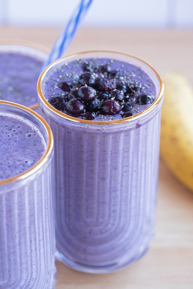 three glasses of blueberry smoothies 